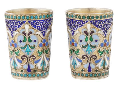 PAIR OF RUSSIAN 84 SILVER AND ENAMEL VODKA CUPS: A pair of Russian 84 gilt Silver and enamel vodka cups. The exteriors of the cups are decorated with polychrome enamel floral, foliage, and scrollwork motifs made in the Cloisonne technique. Marked wi