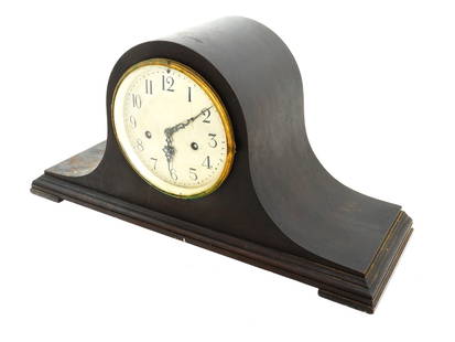 ANTIQUE AMERICAN MANTEL CLOCK BY SETH THOMAS COMPANY: An antique American wooden mantel clock by the Seth Thomas Clock Company. The clock is dark brown with a rounded shape and a face with Arabic numerals. Marked on the dial: Made by Seth Thomas in USA.