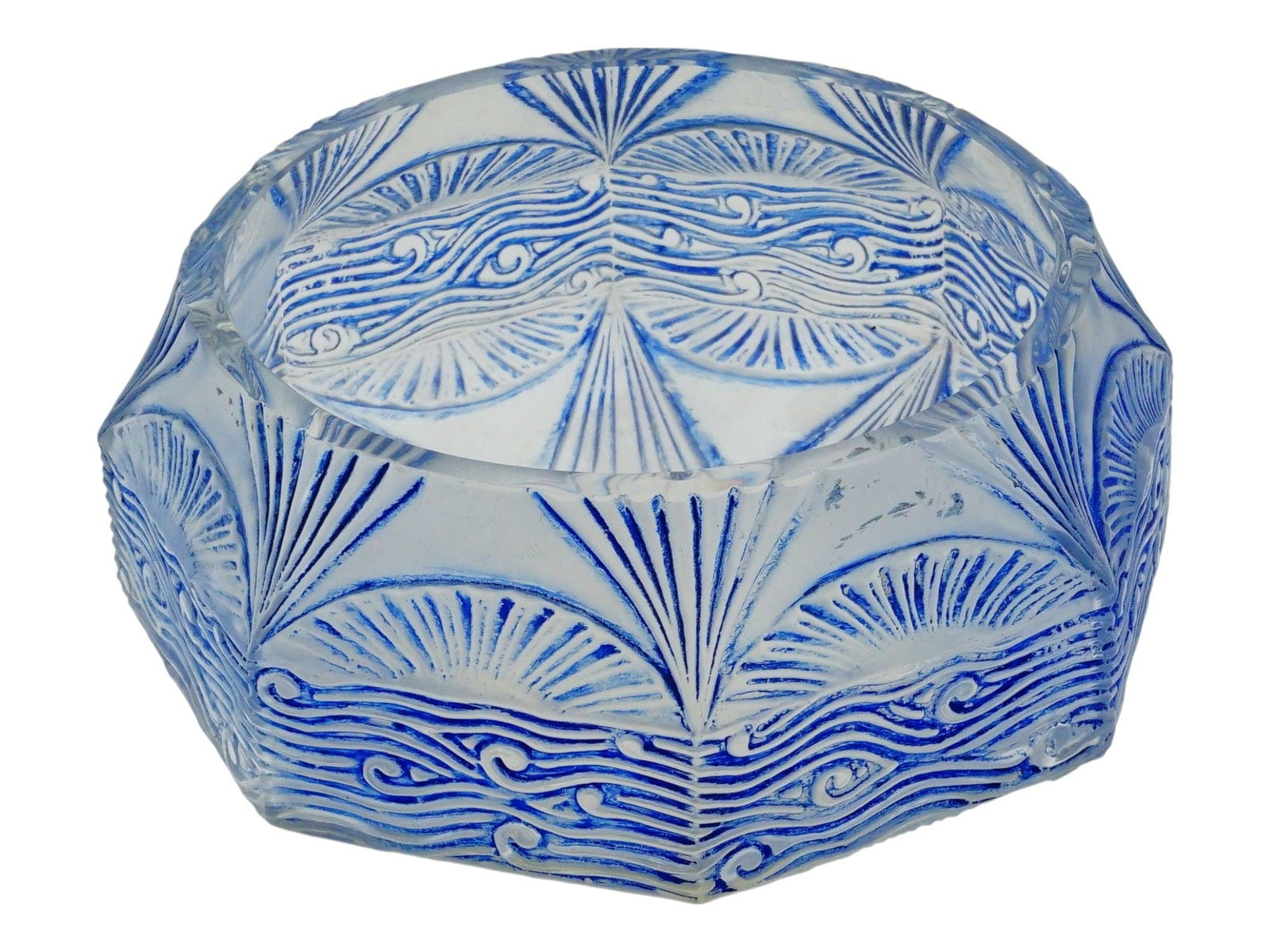 ART DECO ART GLASS SEAWAVE RELIEF ASHTRAY: A clear glass ashtray. Art Deco, ca. 1920s to 1930s. Faceted round piece with relief sea and sun motifs. Painted blue accents. Unmarked. Collectible Tobacciana Accessories, Art Glassware. THIS