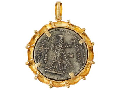 ANCIENT PTOLEMY TETRADRACHM SILVER COIN PENDANT: An ancient Ptolemy Tetradrachm silver coin set in a modern setting gold-over-silver pendant. Ptolemaic Egypt period, circa 150 to 50 BC. Profile of a ruler on the obverse, eagle standing left on a thu