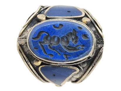 ANCIENT PERSIAN SILVER LAPIS LAZULI INTAGLIO RING: An ancient Persian silver hand carved Lapis Lazuli stone intaglio ring. Circa 200 AD. The ring features a silver base set with an oval shaped Lapis Lazuli stone with an engraved image of a mythical cr