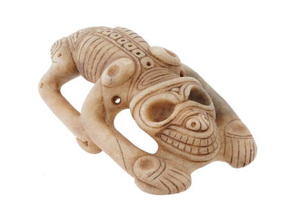 ANCIENT PRE COLUMBIAN TAINO MARBLE ZOOMORPHIC FIGURE: An ancient Pre-Columbian Taino carved marble prone zoomorphic figure, distinguished by its exaggeratedly long legs and dynamic posture. The figure reveals a second face when viewed from above, cleverl