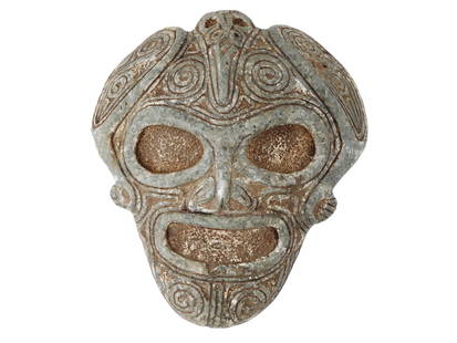 ANCIENT PRE COLUMBIAN TAINO MARBLE ANCESTRAL MASK HEAD: An ancient Pre-Columbian Taino carved marble ancestral mask or head, notable for its impressive scale and detailed craftsmanship. A large bird is depicted resting on the forehead, symbolizing a shaman