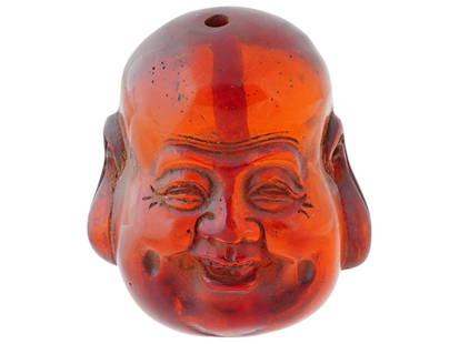 ANTIQUE CHINESE QING CARVED AMBER BUDDAH BEAD: An antique Chinese hand-carved cherry amber bead. Late Qing era, 19th century. The piece represents the head of Laughing Buddha, also known as Fat Buddha or Budai. Fine detail work. Collectible Chines