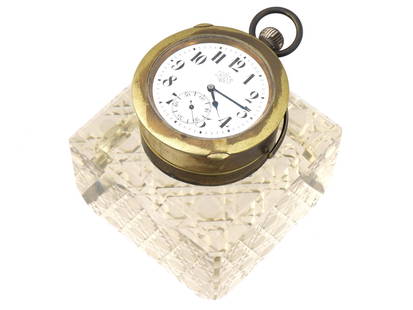 ART NOUVEAU CUT CRYSTAL INKWELL WITH POCKET WATCH: An antique early 20th-century pocket watch inkwell. Art Nouveau era. The inkwell of square shape made from clear glass with hand cut diamond quilt pattern to the exterior. The lid of the inkwell mount