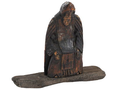 ANTIQUE 18TH C RUSSIAN HAND CARVED WOOD ICON FIGURINE: An antique 18th century Russian hand carved wooden icon figure, portrays a saint figure with a long beard. The carved figure is robed and hooded, standing on a simple wood base, and exhibits significa