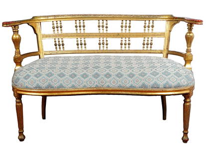 ANTIQUE FRENCH LOUIS XVI STYLE GILTWOOD SOFA: An antique French Louis XVI style giltwood sofa. Crafted with meticulous attention to detail, the sofa showcases the exquisite craftsmanship of the era. Its giltwood frame features delicate carvings,