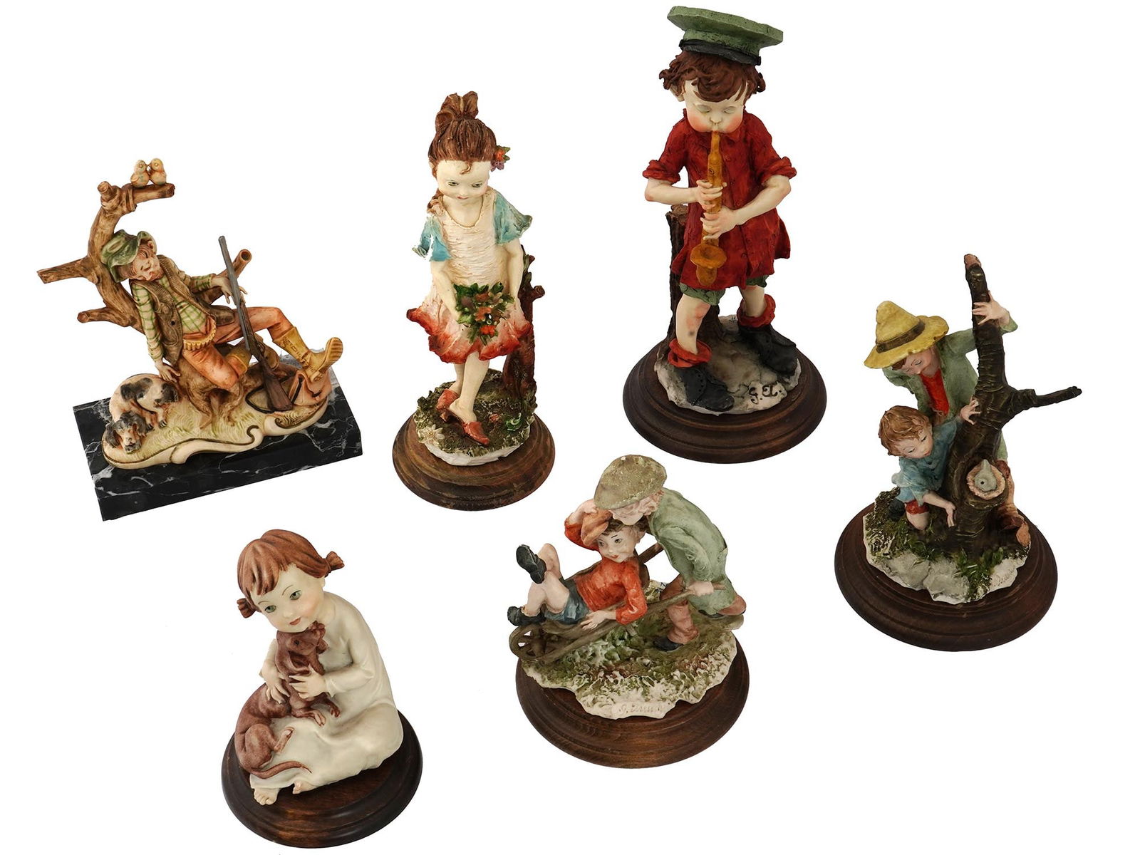 ITALIAN COMPOSITE FIGURINES BY GIUSEPPE ARMANI: A lot of six vintage Italian composite figurines by Giuseppe Armani. The lot includes five figurines of children engaged in various activities on round wooden stands. One figurine of a sleeping hunter