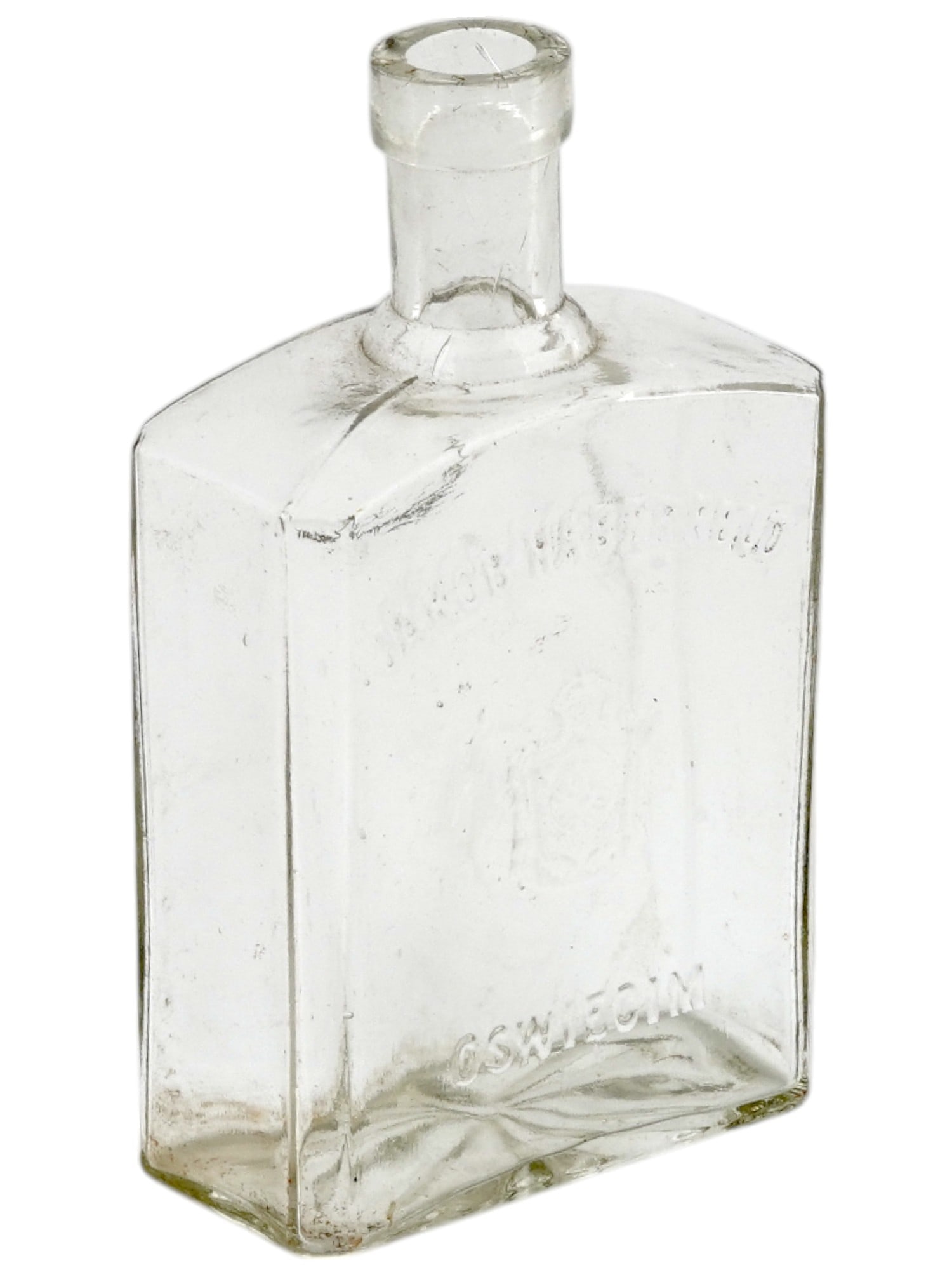 WWII JAKOB HABERFELD LIQUOR BOTTLE FROM AUSCHWITZ: A rare original clear glass bottle manufactured for the Jakob Haberfeld vodka and liquor factory at Oswiecim, Auschwitz, Poland. Ca. 1930s. Relief family coat-of-arms and inscription Jakob Haberfeld O