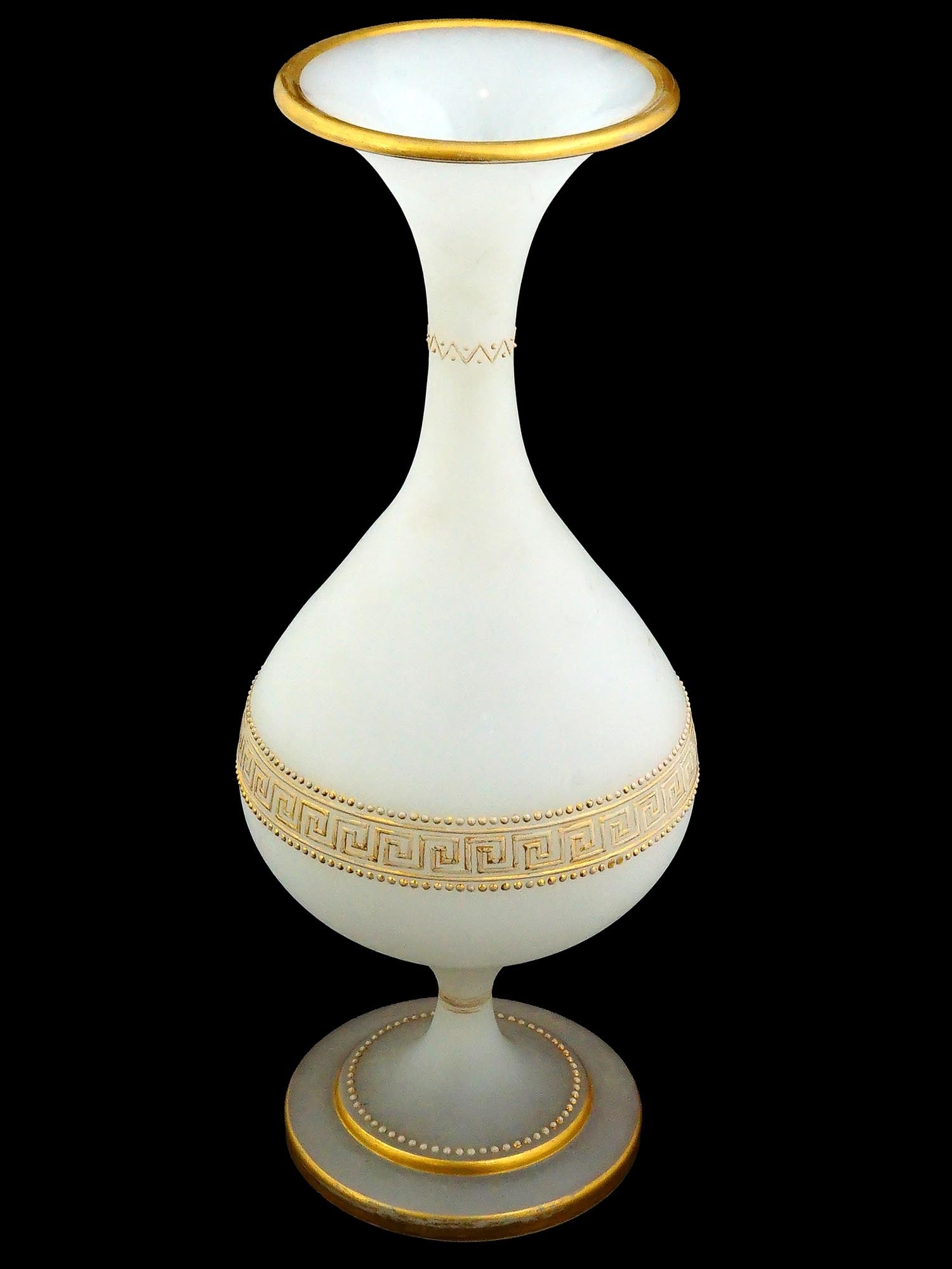 VINTAGE WHITE FROSTED GLASS VASE W GRECO ROMAN PATTERN: A vintage vase made of white frosted glass. The vase has an unusual, strongly curved shape with a round body and a neck widening upwards. The body of the vase is decorated with repeated decor based on