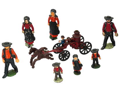 2 CAST IRON AMISH FAMILIES AND FIREMAN WAGON TOYS: A set of eight vintage hand colored cast iron figurines of two Amish families and a fireman wagon with horses. The figurines depict two pairs of adults and three children dressed in traditional clothe