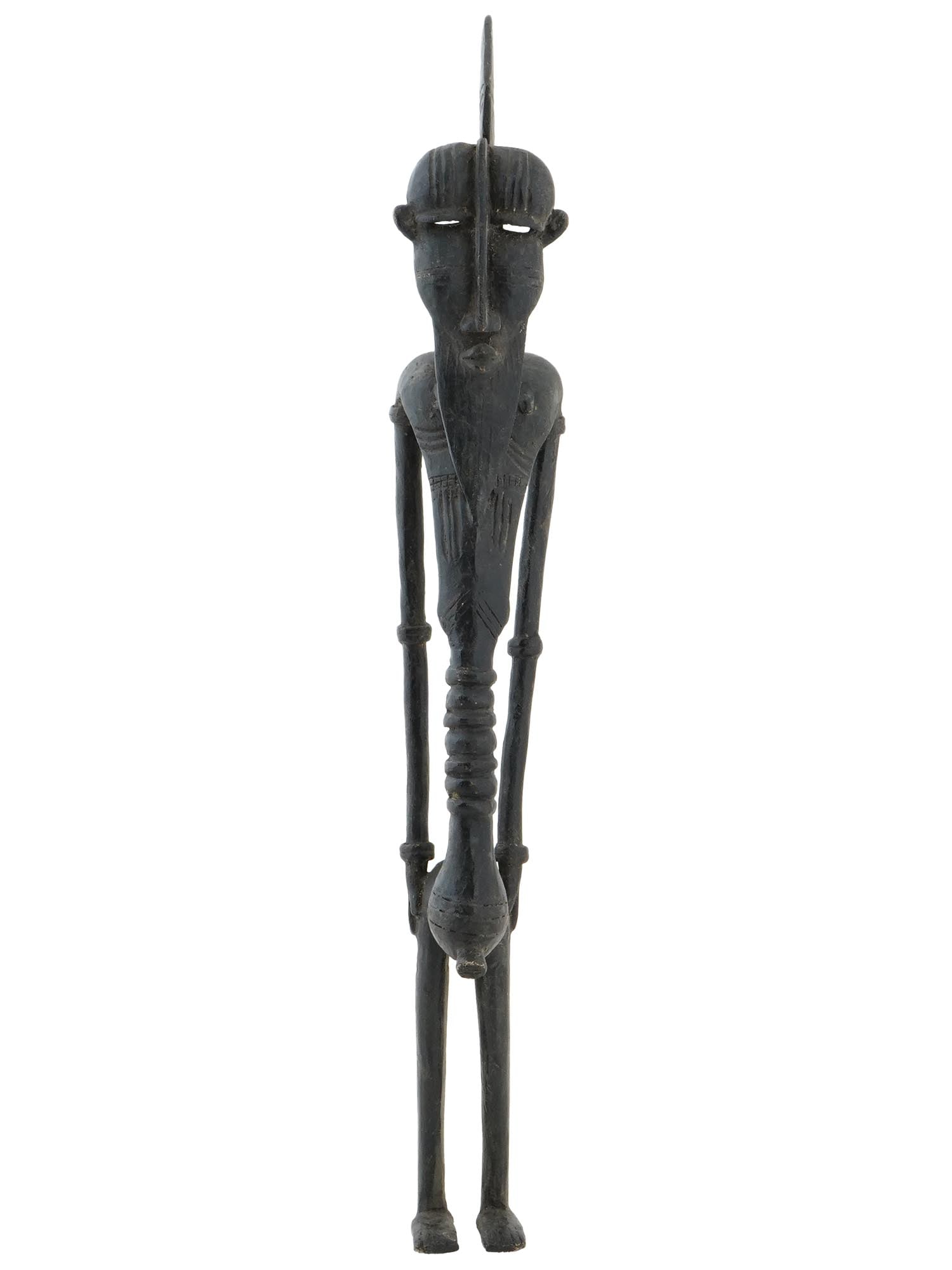 WEST AFRICAN DOGON TRIBE BRONZE MALE FIGURINE: A West African Dogon Tribe dark patinated bronze statue. The statue depicts an elongated nude bearded male wears a crown with long arms to the sides, a thin stomach and exaggerated groin area. He has 
