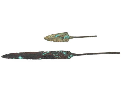 TWO ANCIENT METAL SPEARHEADS OF DIFFERENT SHAPES: A lot of two ancient metal spearheads. The spearheads are of different shapes and sizes, shorter and longer. Both have a thin, elongated base, apparently inserted into the body of the spear. Ancient A