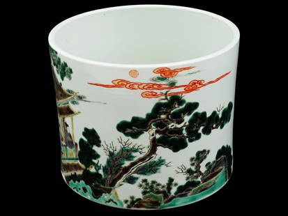 ANTIQUE CHINESE QING ENAMEL PORCELAIN PEN HOLDER: An antique Chinese, Qing Dynasty, hand enamel porcelain pen holder. The exterior of the holder is adorned with a polychrome hand enameled design depicting a landscape with scholars in a house and a po