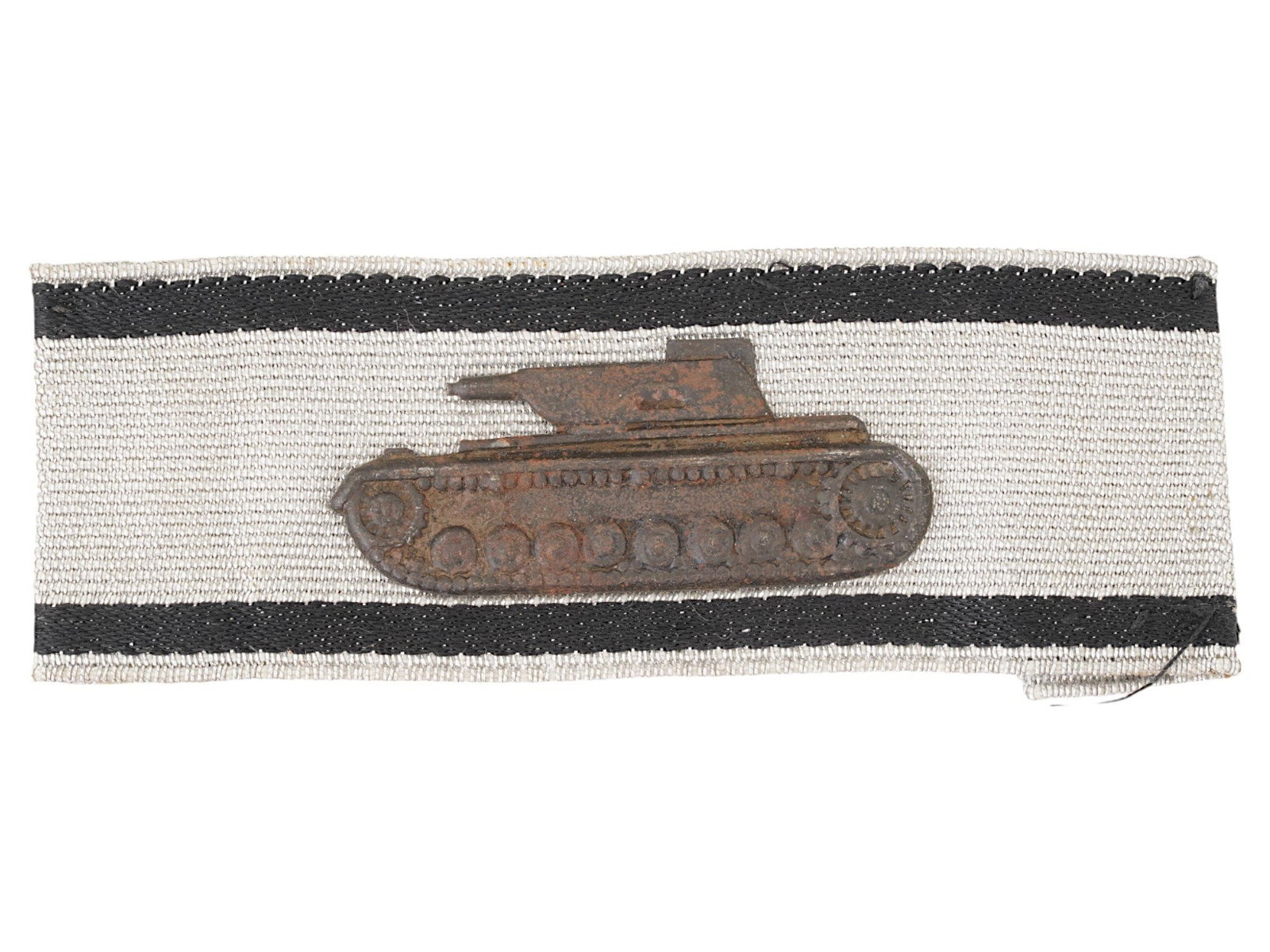 WWII NAZI GERMAN TANK DESTRUCTION BADGE IN SILVER: A WWII Nazi German Tank Destruction Badge in silver. Features a blackened Panzer IV tank attached to a silver band with black stripes. The badge was pinned to the sleeve and then was sewn on. With a c