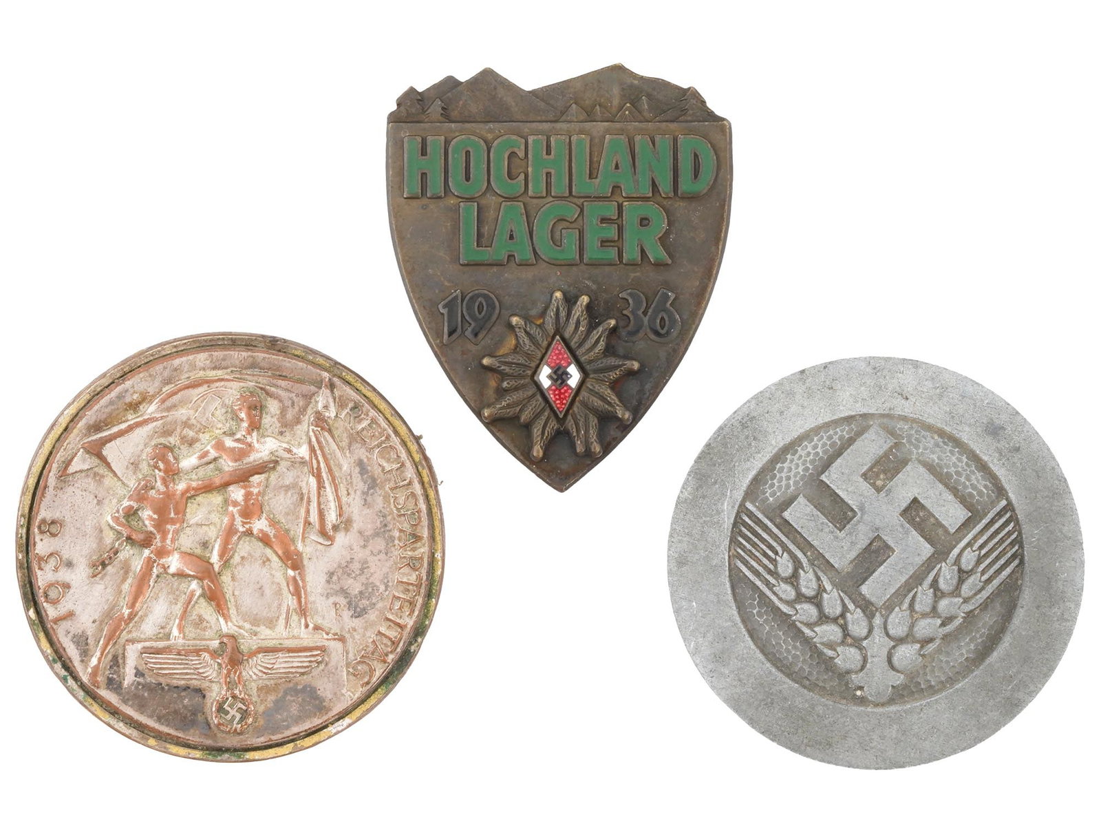 WWII NAZI GERMAN PROPAGANDA CAMPAIGN PIN BADGES: A group of three WWII Nazi German pin badges related to youth and territorial propaganda campaigns, Hitler-Jugend Hochland Lager 1936 badge, October 1938 Sudetenland badge, RAD Female Youth badge. Sec