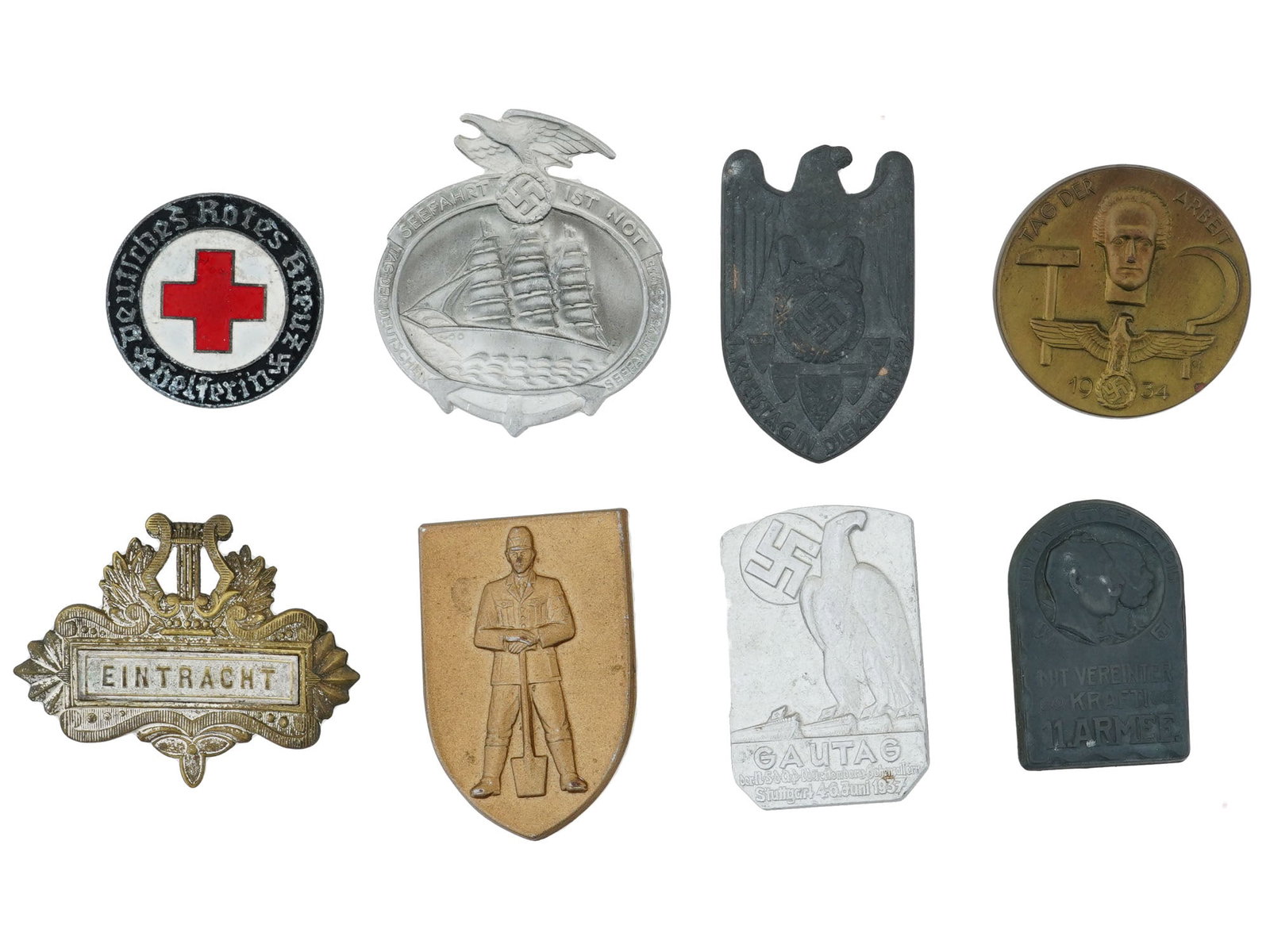 PRE WWII AND WWII NAZI GERMAN PROPAGANDA PIN BADGES: A group of eight pre-WWII and WWII Nazi German pin badges, each commemorating events or organizations tied to the Third Reich. Included is a German Red Cross Helpers badge, German Maritime Day 1935 ba