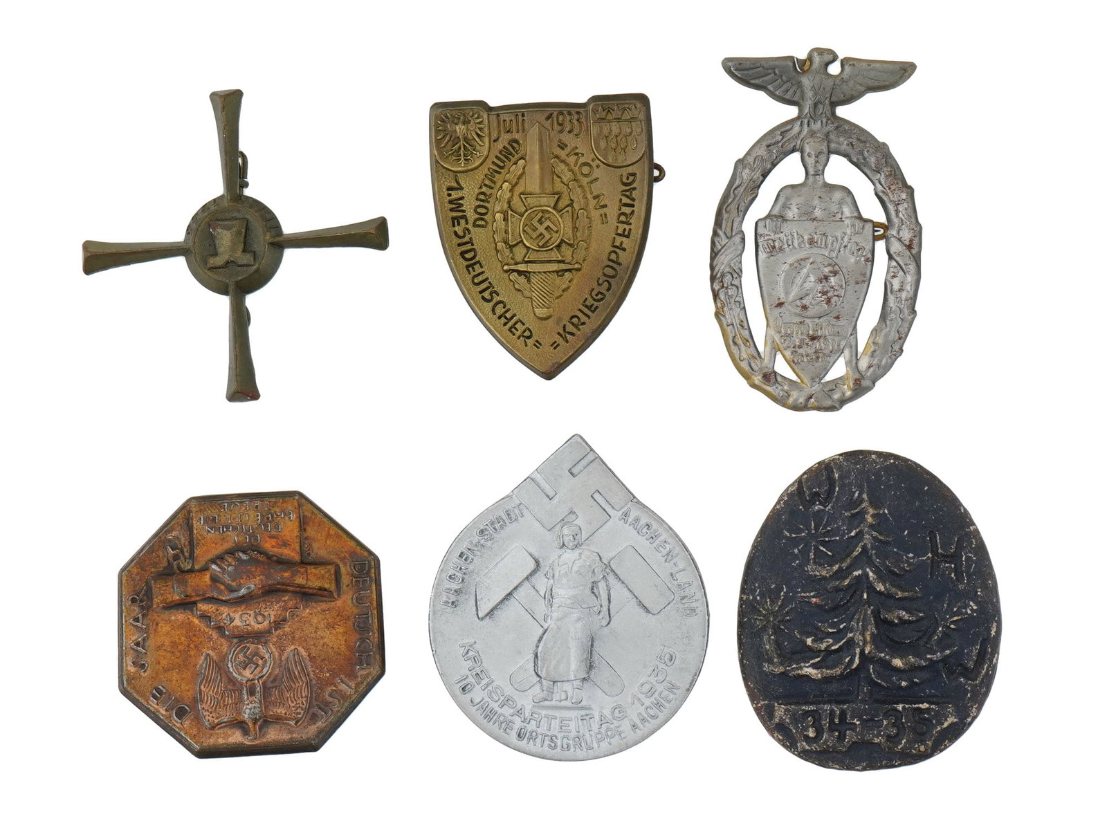 PRE WWII NAZI GERMAN THIRD REICH PROPAGANDA PIN BADGES: A group of six pre-WWII Nazi German pin badges, each reflecting significant propaganda events and regional rallies of the early Third Reich period. Included are Trier Kirchentag 1933 badge, NSKOV Dort