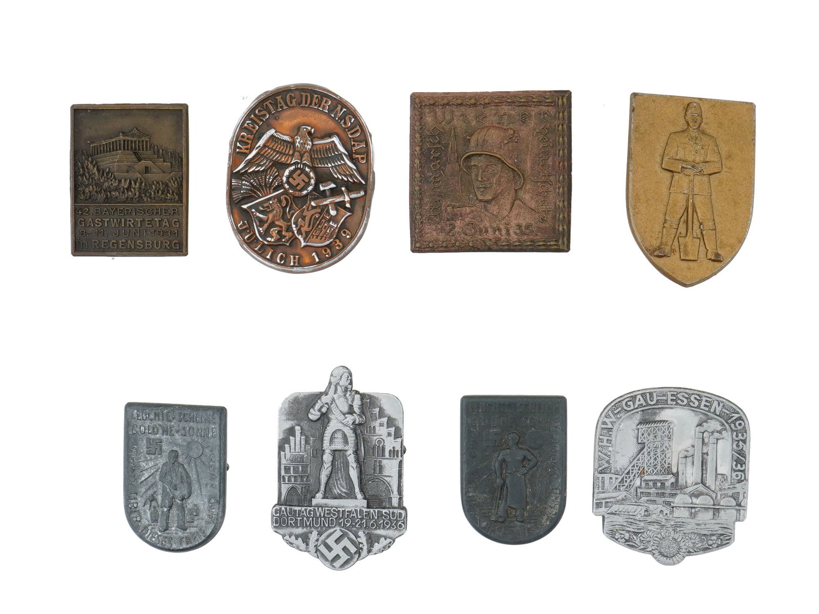 PRE WWII NAZI GERMAN THIRD REICH PROPAGANDA PIN BADGES: A collection of eight pre-WWII and WWII-era German pin badges representing various nationalistic, regional, and propaganda events tied to the Nazi regime. Included are 42nd Bavarian Innkeepers Day in 
