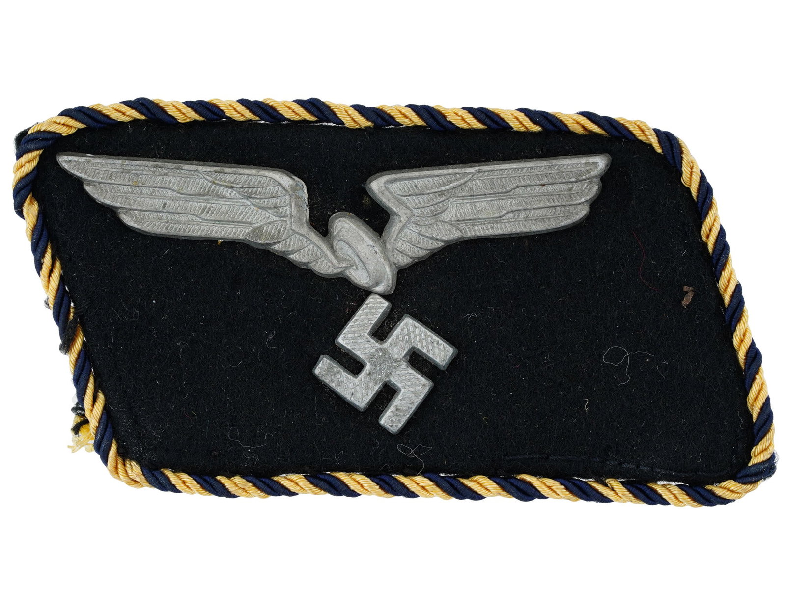 WWII TYPE GERMAN RBD RAILROAD OFFICIALS COLLAR TAB: A WWII type Nazi German RBD Reichsbahn Railroad Officials collar tab. Black wool construction collar tab with stamped metal alloy winged wheel, positioned above a canted, pebble finished swastika. Com