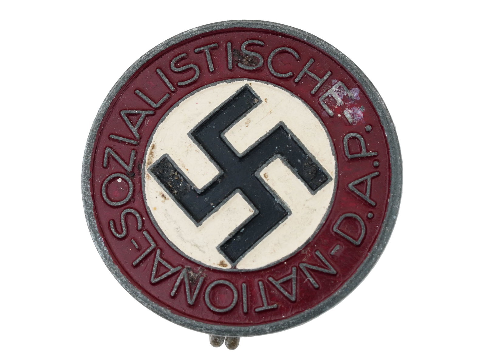 WWII MODEL GERMAN THIRD REICH NSDAP PARTY BADGE: A WWII model Nazi German Third Reich political NSDAP party badge. The front reads, National Sozialistische D. A. P. The badge is enameled with a swastika insignia in the center. Has a thin horizontal 