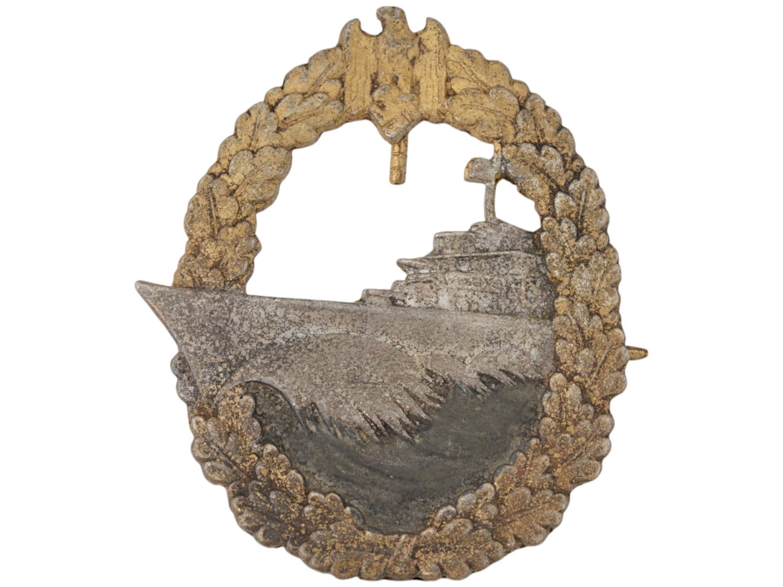WWII NAZI GERMAN KRIEGSMARINE DESTROYER WAR BADGE: A WWII Nazi German Kriegsmarine Destroyer War badge, featuring an outer oak leaf laurel wreath encircling the design, with the German national emblem, an eagle clutching a swastika, at the apex. The c