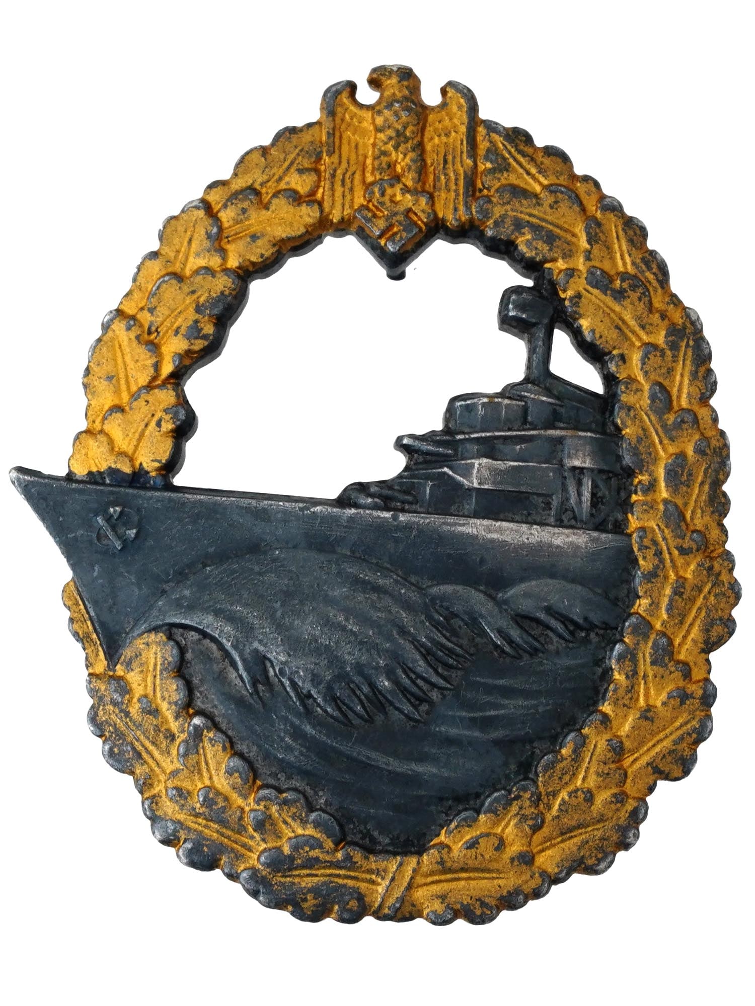 WWII NAZI GERMAN KRIEGSMARINE DESTROYER WAR BADGE: A WWII Nazi German Kriegsmarine Destroyer War Badge, featuring an outer oak leaf laurel wreath encircling the design, with the German national emblem, an eagle clutching a swastika, at the apex. The c