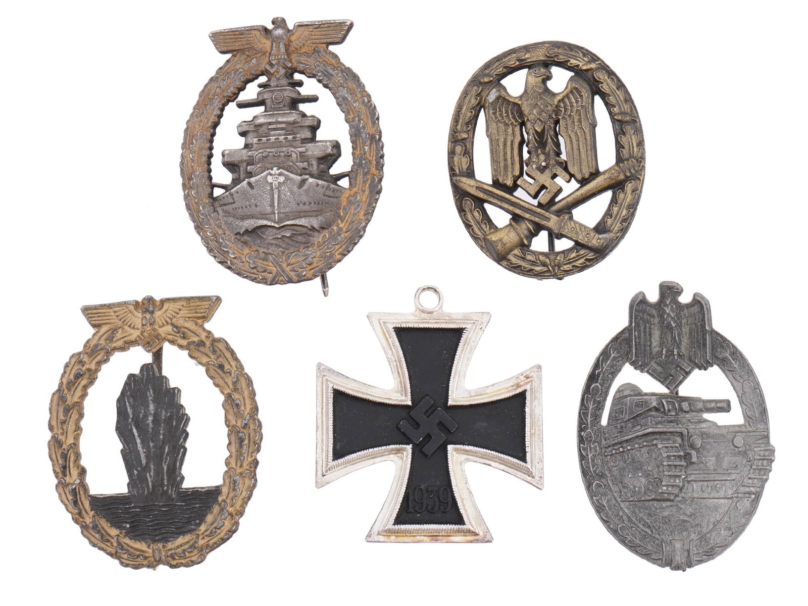 FOUR WWII NAZI GERMAN BADGES AND IRON CROSS MEDAL: Four WWII Nazi German pin badges including a Minesweeper War badge, a High Seas Fleet badge, a General Assault badge, and a Panzer badge. The lot also includes an Iron Cross medal, 2nd class featuring