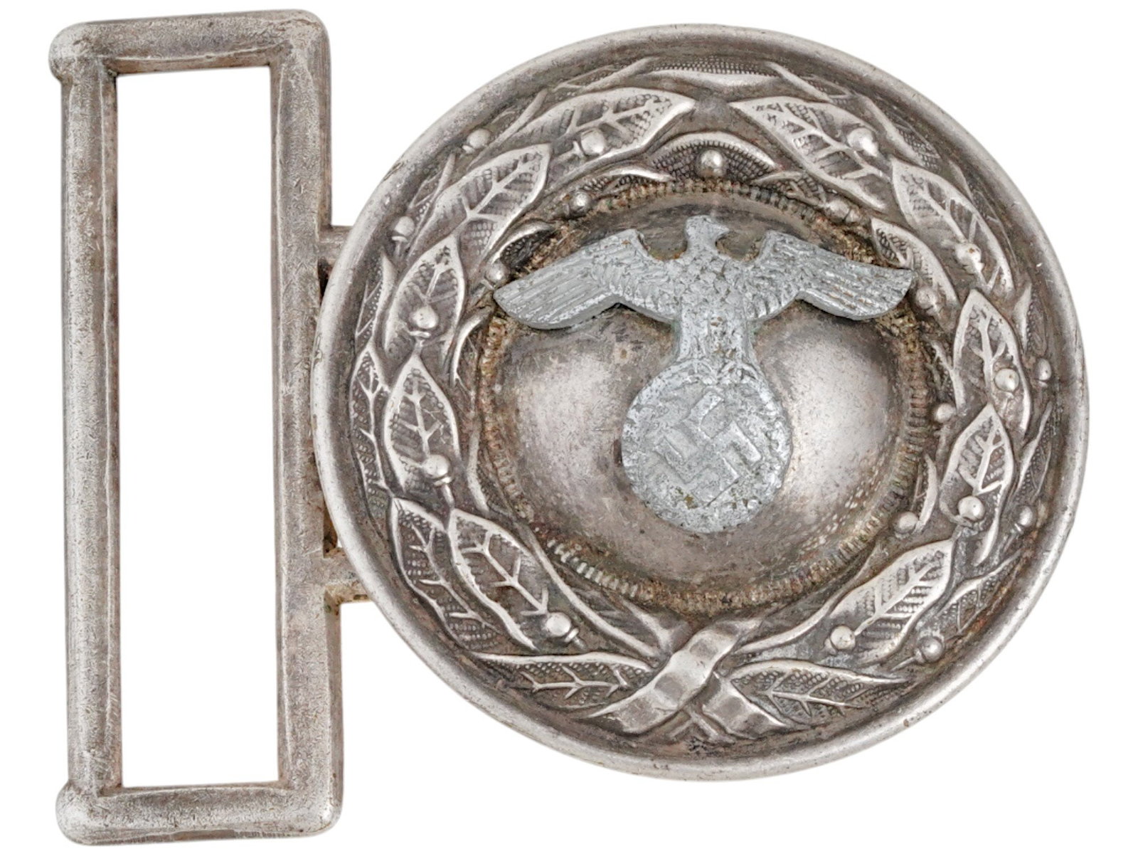 NAZI GERMAN WWII MODEL NSDAP OFFICIAL BELT BUCKLE: A WWII type NSDAP Nazi German Official belt buckle. The front is embossed with a round oak leaf wreath, encompassing a slightly domed inner field with a German eagle with a swastika insignia to the ce