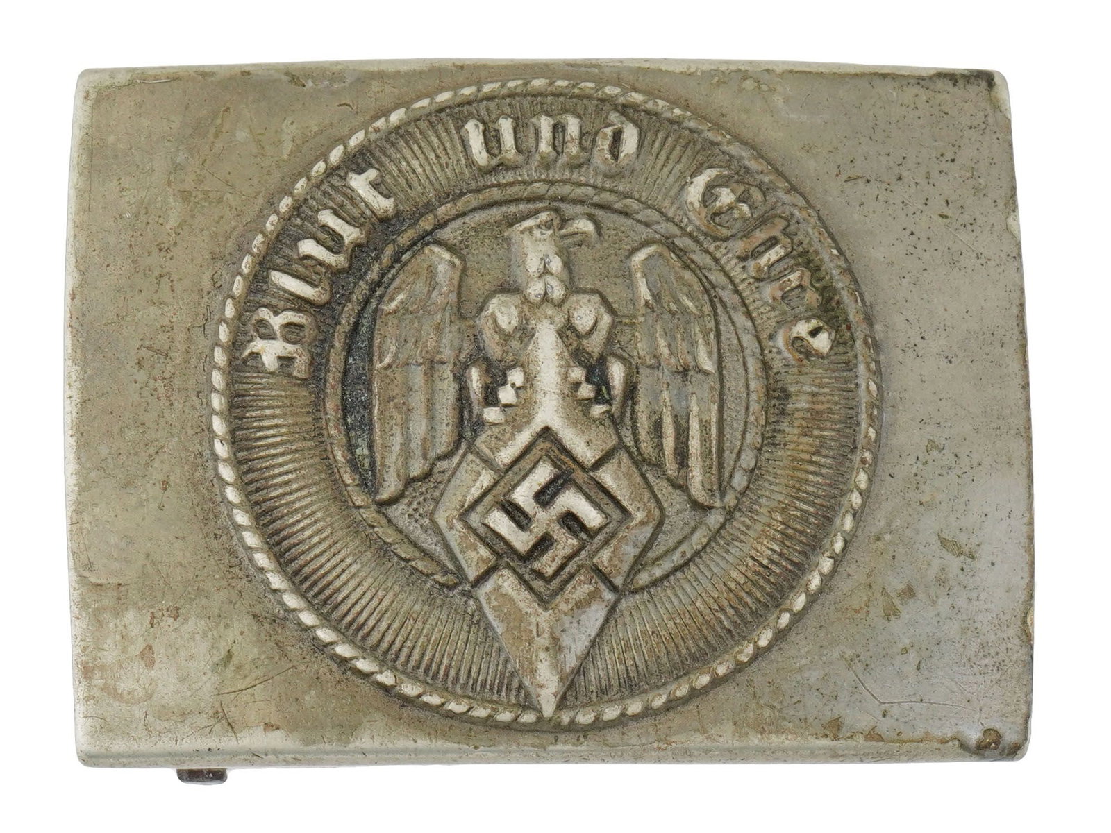 WWII MODEL GERMAN NAZI HITLER YOUTH BELT BUCKLE: A WWII type German Nazi Hitler Youth belt buckle for an enlisted man. The front is engraved with a motto in German, Blut und Ehre, translated to Blood and Honor, and the Hitler Youth eagle clutching t