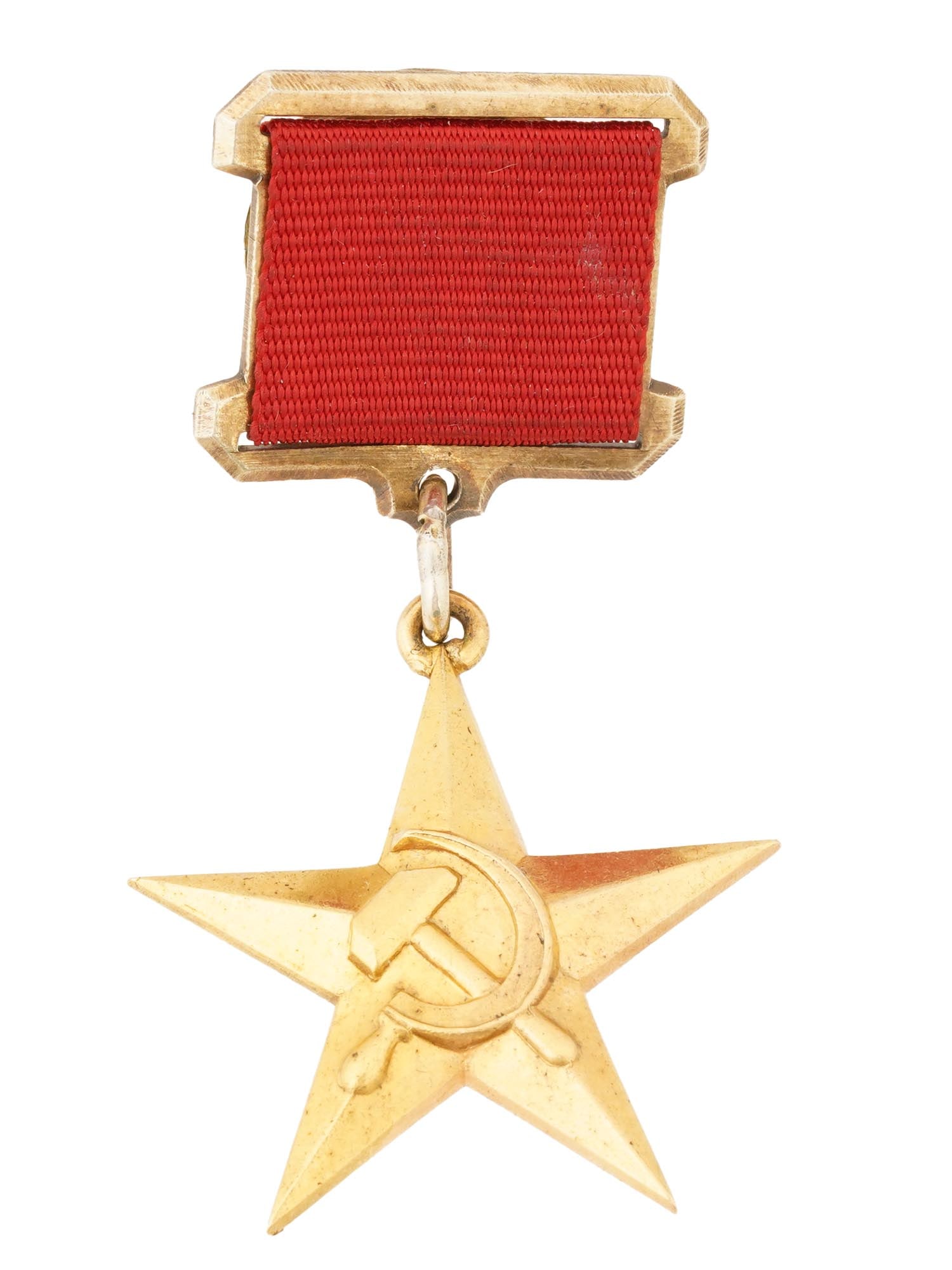 SOVIET GOLD STAR OF THE HERO OF SOCIALIST LABOR BADGE: A Russian Soviet gold star of the Hero of Socialist Labor badge. The medal consists of a gold star with a raised hammer and sickle emblem in the center. Inscribed Hero of Socialist Labor badge on the