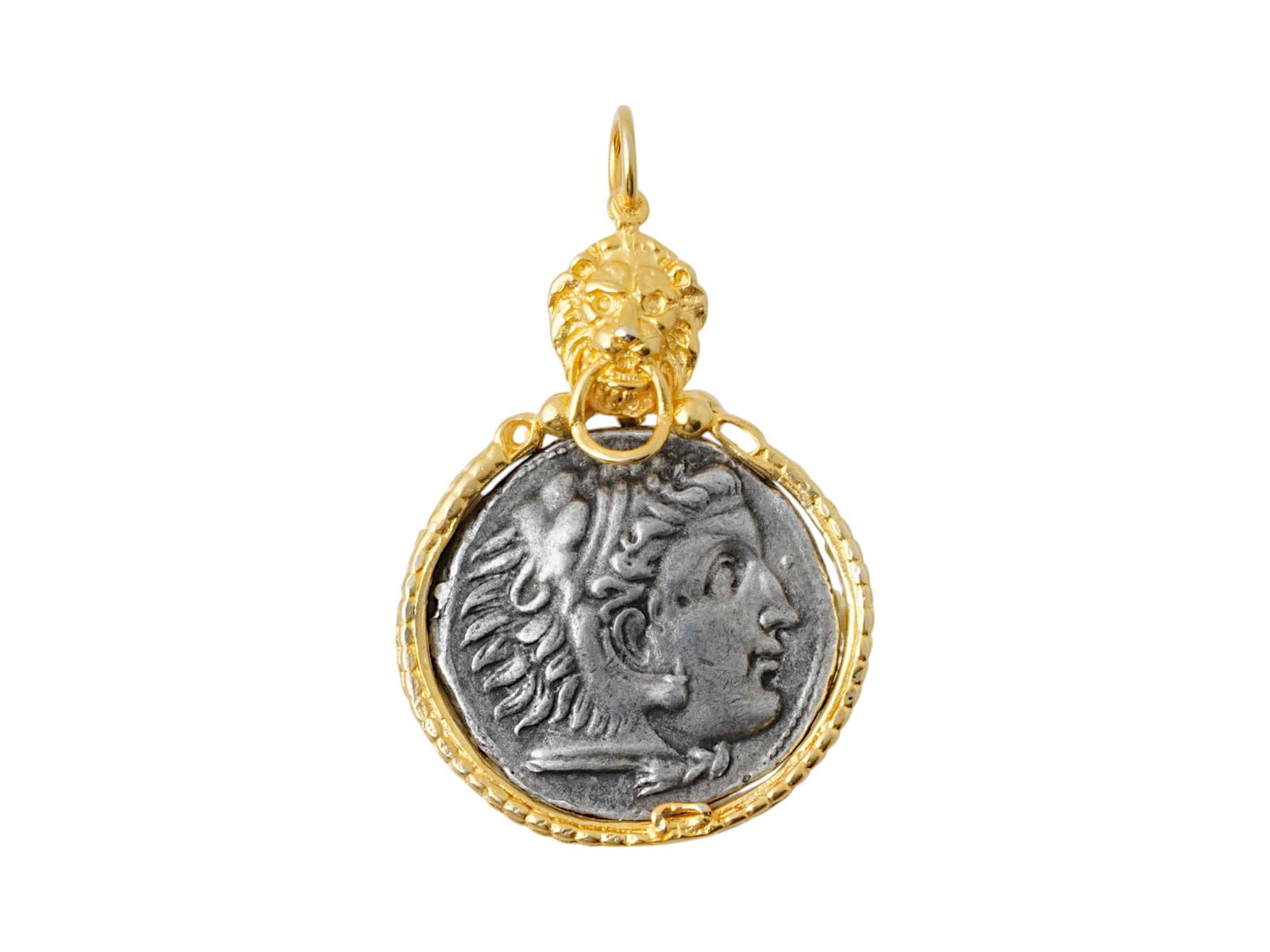 ALEXANDER THE GREAT TETRADRACHM SILVER COIN PENDANT: An ancient Greek silver Tetradrachm coin, Alexander the Great rule, ca. 336 to 323 BC. The coin is set in a modern gold over silver pendant setting, topped with a lion motif. This elegant fusion of cl
