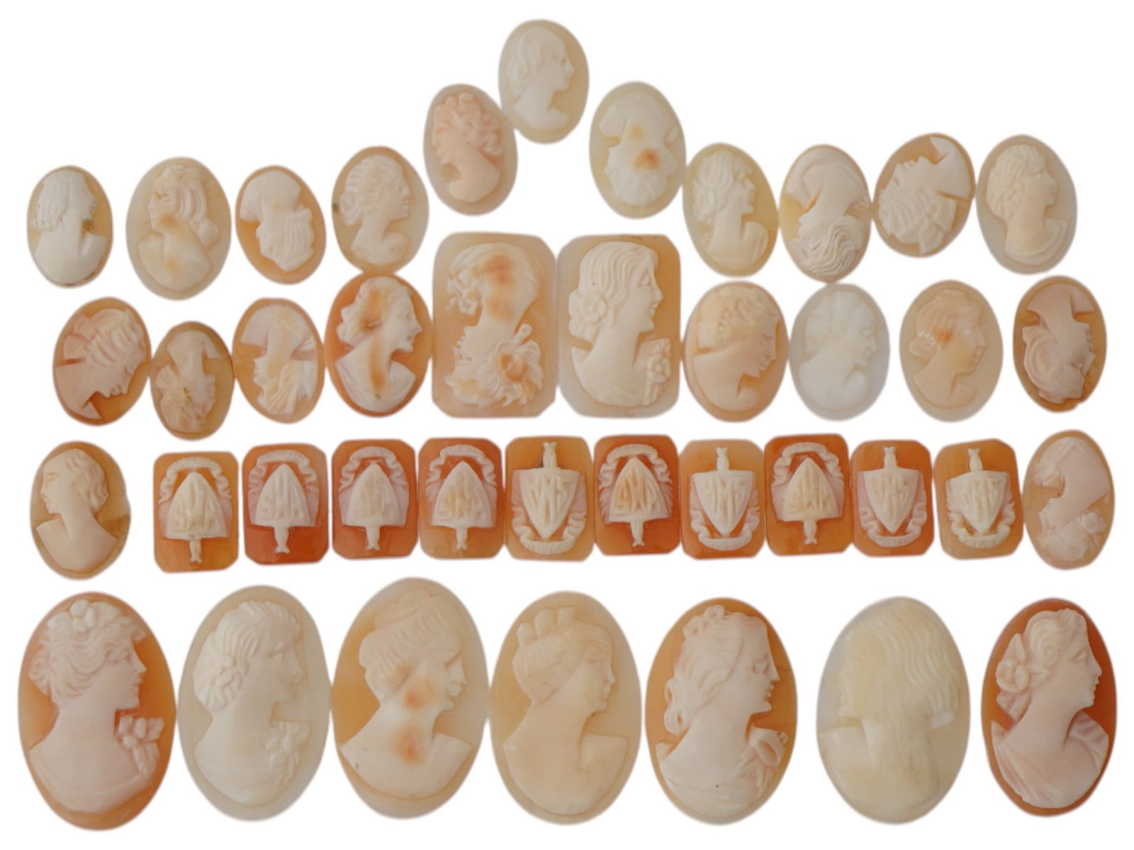 COLLECTION OF PORTRAIT CARVED SHELL CAMEO MEDALLIONS: A collection of assorted vintage cameo medallions in various sizes and shapes. Each oval or octagonal cut shell cameo depicts a relief female portrait in profile in the Victorian and Roman manners, an