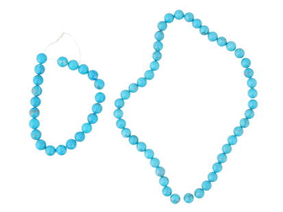 COLLECTION OF ROUND SHAPED TURQUOISE BEADS FOR NECKLACE: A collection of round shaped turquoise beads strung together ready to be crafted into a necklace. The beads exhibit the vibrant blue and green hues typical of turquoise, along with unique natural vein