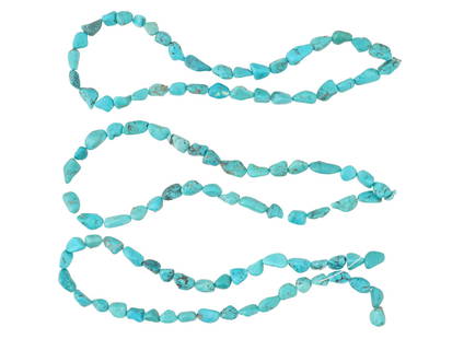 LOT OF NATURAL SHAPED TURQUOISE BEADS FOR NECKLACE: A collection of turquoise beads of natural shape, strung on cords, ready to be crafted into a necklace. The beads exhibit the vibrant blue and green hues typical of turquoise, along with unique natura
