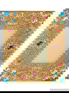 RELIEF DESIGN GILDED BRASS PICTURE FRAME MARKED: A vintage gilded brass picture frame. The frame features a relief design, adorned with decorative elements that include colorful stones and pearls, set against the gold tone background. The ware is de