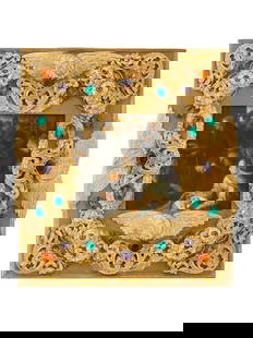 RELIEF EAGLE DESIGN GILDED BRASS PICTURE FRAME: A vintage gilded brass picture frame. The frame features a relief design, adorned with decorative elements that include colorful stones set against the gold tone background. The ware is decorated with