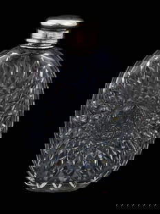 CRYSTAL GLASS CUT DESIGN LIQUOR FLASK WITH SILVER LID: A vintage crystal glass liquor flask bottle. The ware is made in a cut glass design. The flask is completed with a Silver lid. Vintage Glass Table Wares, Alcohol Bottles, and Collectibles. THIS