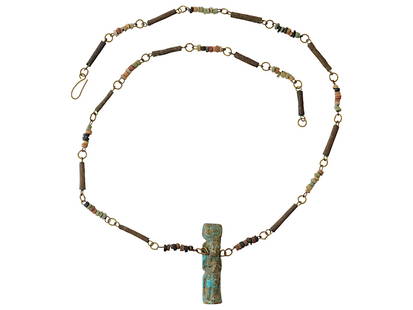 ANCIENT EGYPTIAN BEADED NECKLACE WITH GOD AMULET: An ancient Egyptian necklace made in a beaded design. The necklace is adorned with an amulet representing Isis and baby Horus, a powerful symbol of motherhood, protection, and rebirth. Presented in a