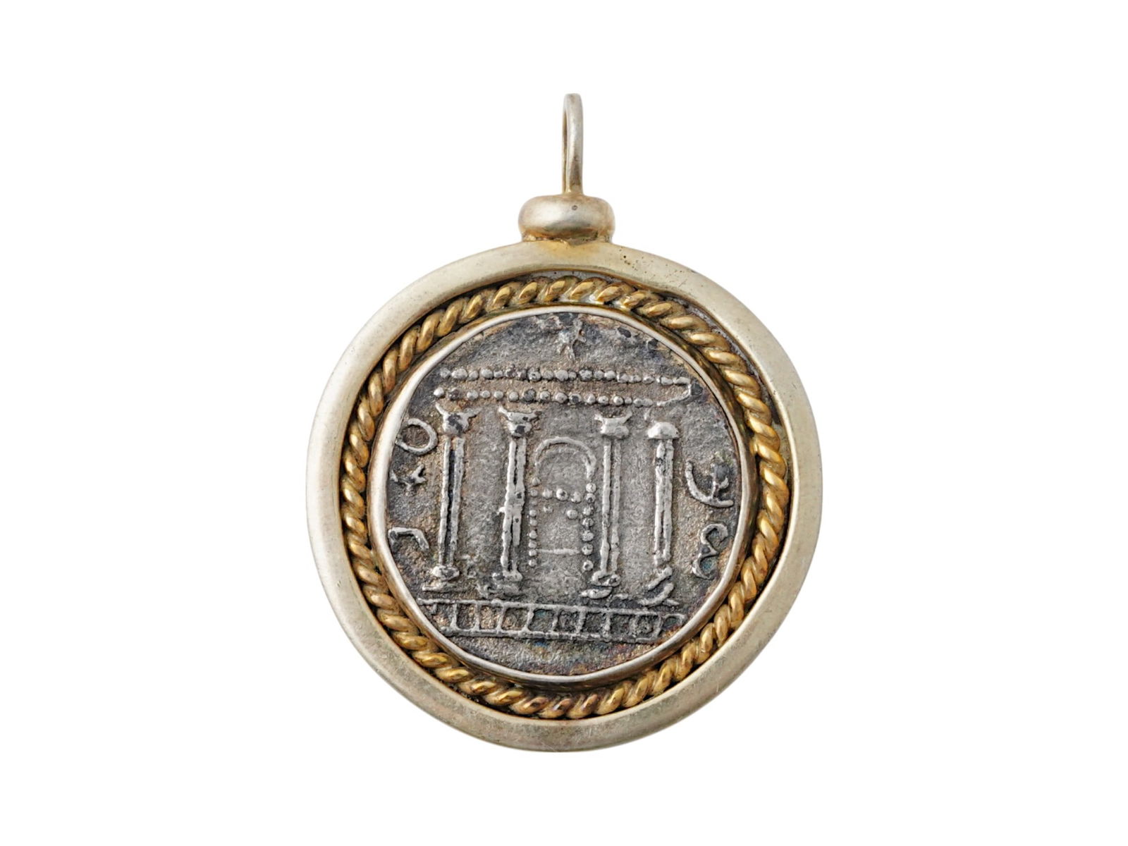 ANCIENT HOLY LAND BARKOKHBA TETRADRACHM SILVER COIN: An ancient Holy Land Barkokhba tetradrachm silver coin. The front depicts temple Jerusalem. Inscriptions on the reverse. Set in a gold over silver modern setting pendant. Circa: 133 to 132 BC. Ancient