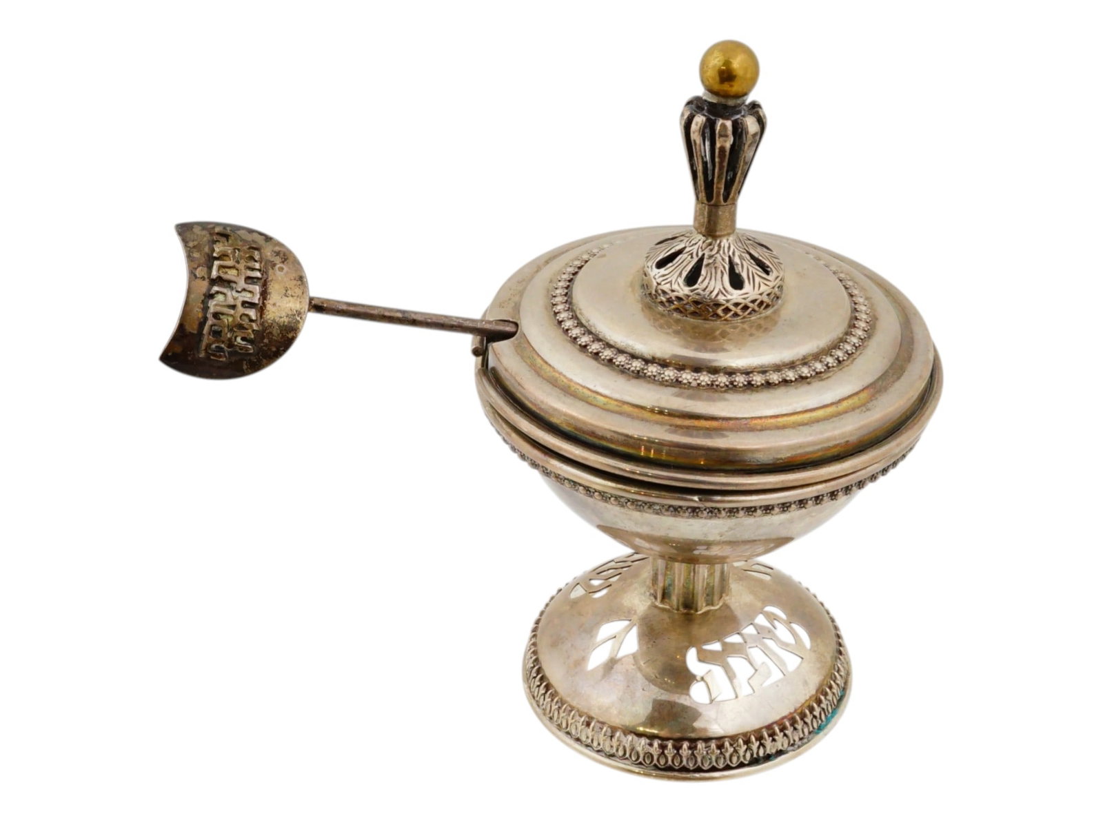 JUDAICA NETAFIM SILVER HONEY DISH FOR ROSH HASHANAH: A vintage Judaica sterling silver honey dish for Rosh Hashanah made by Netafim. Circa mid 20th century. The covered dish is adorned with chased details, gilded accents and pierced through Hebrew writi