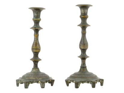 PAIR OF ANTIQUE 18TH CEN POLISH CANDLESTICKS: A pair of antique Polish candlesticks, dating from the 18th century. They are made of a dark metal, likely bronze or brass. The candlesticks have a traditional design, with a round flared base, a slen