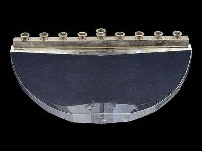 JUDAICA STEUBEN CRYSTAL GLASS MENORAH CANDLE HOLDER: A Judaica Steuben crystal glass menorah designed by Joel Smith. Circa: 1992. The hand polished and hand cut crystal form features nine sparkling silver plated candle cups reflecting the warm glow of C
