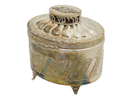 VINTAGE JUDAICA HAZOREIM STERLING SILVER ETROG BOX: A vintage Judaica sterling silver etrog box with a hinged lid, decorated with floral designs on the body, standing on four feet. The lid features an openwork finial with Hebrew letterings. Marked Hazo