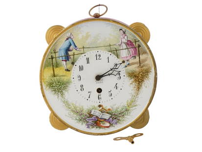 FRENCH DRUM FORM HAND PAINTED CERAMIC WALL CLOCK: A French patinated metal and ceramic wall clock. The clock is made in a drum design. A white enameled dial with Arabic numerals featuring a hand painted gallant scene, floral, foliage and musical inst