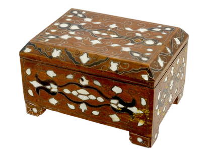 ANTIQUE SYRIAN WOODEN BOX INLAID W MOTHER OF PEARL: An antique Middle Eastern Syrian wooden trinket or jewelry box inlaid with mother of pearl. The lidded rectangular jewelry box is decorated with ornamental foliate decor. The item is mounted on four l