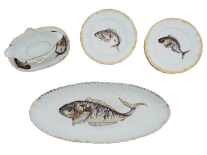 VINTAGE GERMAN PORCELAIN FISH TABLEWARE SET: A set of vintage German hand-painted porcelain tableware. A total of 13 items, including 10 dinner plates, a sauceboat with saucer, and an oval serving plate. Each plate features an image of a saltwat