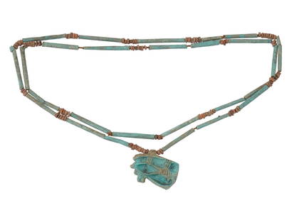 ANCIENT EGYPTIAN BEADED NECKLACE W HORUS AMULET: An Ancient Egyptian beaded necklace. Ptolemaic Egypt, ca. 305 to 30 BC. Blue-glazed faince beads and pendant representing Eye of Horus, one of the most significant ancient Egyptian deities, the god of