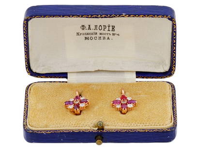 RUSSIAN GOLD EARRINGS WITH DIAMONDS AND RUBIES: A pair of Russian yellow gold cluster earrings with diamonds and rubies. The design features a central round white diamond cabochon encompassed with 4 rubies and 4 diamonds. Marked with Russian hallma
