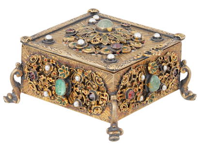 ANTIQUE GILT SILVER JEWELRY BOX RUBIES EMERALDS PEARLS: An antique gilt silver filigree jewelry box, rectangular in shape and raised on four fish-shaped feet. The box is beautifully applied with marine motifs and features intricate openwork bosses mounted